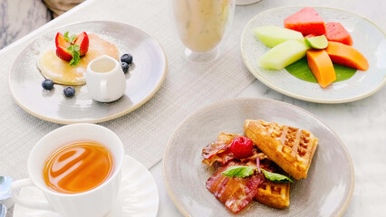 Sweet breakfast in cafe with belgian waffles, pancakes with berries