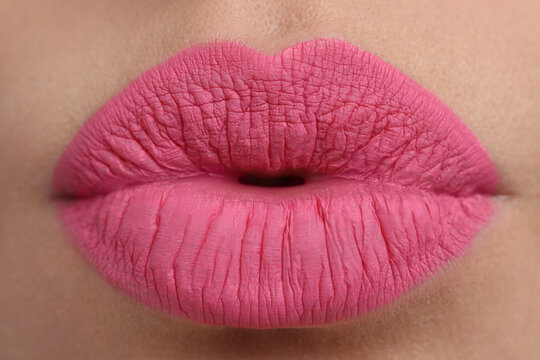 Closeup view of beautiful woman puckering lips for kiss