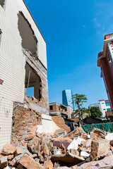 Contrast of demolished old house and modern skyscraper