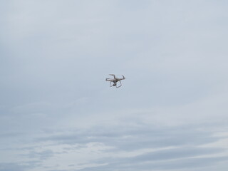 Fototapeta na wymiar Drone flying in cloudy sky.
