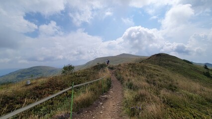 A silhouette of a tourist and a stunning view of the mountains. Bieszczady National Park, the Carpathians, Poland.