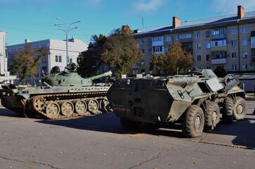 Military equipment stands on the streets of the city 