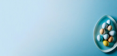 Colorful Easter eggs on a pastel blue banner background