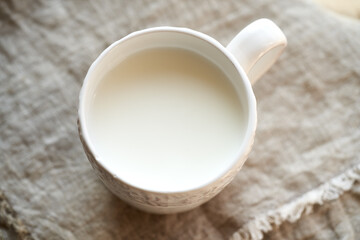 Fresh probiotic kefir in a white cup, top view