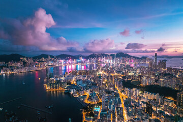 Fototapeta na wymiar Futuristic cyberpunk view of the famous metropolis, night aerial view of Kowloong Hong Kong.