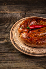 baked meat sausages on a wooden board. banner menu recipe place for text