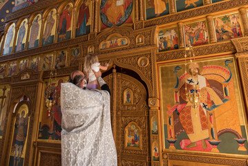 Obraz premium priest shows orthodox christian altar to a child