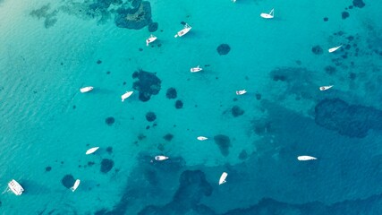 Fototapeta na wymiar Aerial shot of a tropical island with anchored boats