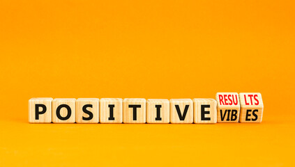 Positive vibes result symbol. Concept words Positive vibes or Positive results on cubes. Beautiful orange table orange background. Business positive vibes results concept. Copy space