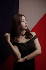 Naklejka premium Young Asian women wear dresses or dark clothes. Take pictures and express themselves inside the indoor studio.