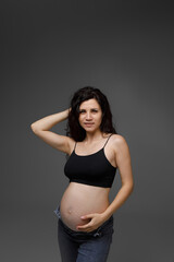 pregnant woman in studio on grey background