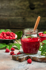 homemade raspberry jam or confiture on light background. vertical image. top view. place for text