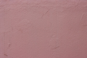 Abstract background of red rough grungy plaster on the wall