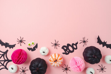Happy Halloween holiday concept. Glitter black pumpkin and party decorations on pink background. Top view, flat lay
