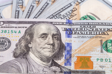 Obraz na płótnie Canvas Pile of 100 dollar banknotes on white background