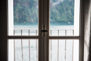 Fototapeta na wymiar A window with Lake Lugano in the background in Switzerland during the summer. 