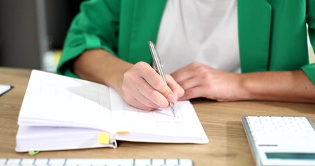 Businesswoman writes plan for working week or month
