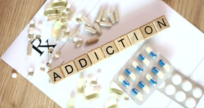 Medical pills laid out on blank prescription text addiction