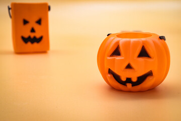 close-up plastic halloween pumpkin on orange background