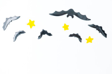 Halloween background with pumpkins and bats, . Above view over an white banner background with copy space.