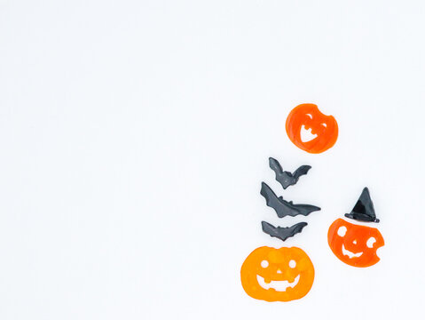 Halloween background with pumpkins and bats, . Above view over an white banner background with copy space.
