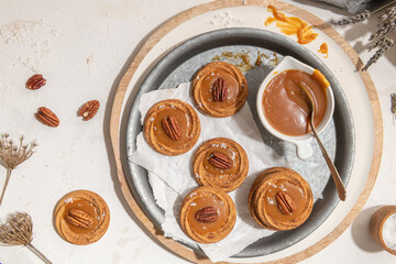 Homemade cookies with a generous dollop of Salted Caramel and pecan nut