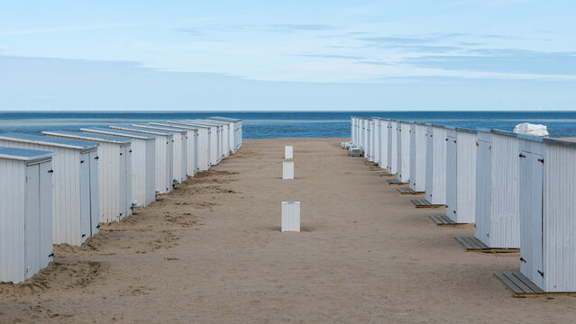 Knokke Heist, Flemish Region - Belgium -  White beach cabins in a row at the sand beach during low season