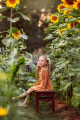 girl with a sunflower, summer in the village, August, vegetable garden