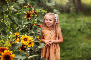 girl with a sunflower, summer in the village, August, vegetable garden