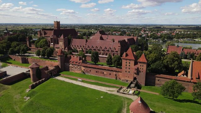View from the drone at the medieval Teutonic Castle in Malbork on the Nogat River on a sunnz ,autumn daz.