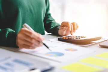 Portrait of a woman working on a tablet computer in a modern office. Make an account analysis...