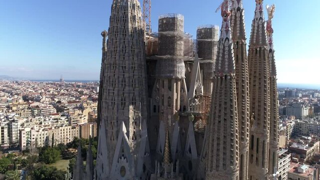 Aerial view of Barcelona city skyline and Sagrada Familia Cathedral at sunrise. Eixample residential famous urban grid. Cityscape with typical urban octagon blocks. Catalonia, Spain