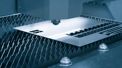 Cutting of metal with sparks fly from laser, modern industrial technology concept