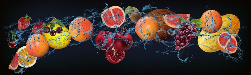 Panorama with fresh fruits in the water - orange, grapefruit, melon, grapes, coconut, kiwi, lemon -...