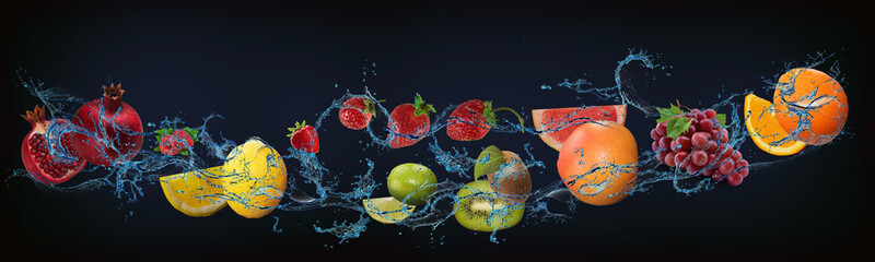 Fototapeta na wymiar Panorama with fresh fruits in the water - strawberry, lime, orange, pomegranate, lemon, kiwi, raspberry, lime, lychee delicious dessert for the New Year, Christmas and Halloween