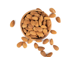 Top view of almond nuts grains in a wooden bowl and on a white background.