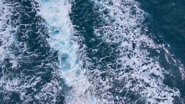 aerial view speed boat cruising in ocean travelling on beautiful blue sea sailing to holiday destination in mediterranean from above