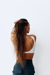 Obraz premium A woman with long hair stands back and takes care of her hair after washing and applying scalp and hair health products. Taking care of your hair at home