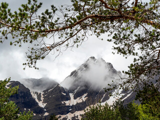 Snowy and misty peaks in the Cirque of Pineta, in the Ordesa National Park, Pyrenees Mountains (Spain).