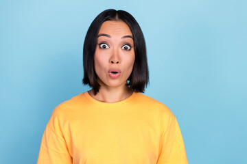 Fototapeta premium Portrait of positive gorgeous nice woman with bob hairdo dressed yellow t-shirt impressed staring isolated on blue color background