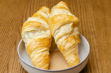 two croissants in condensed milk
