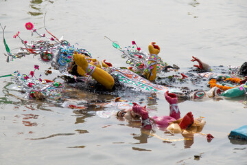 Idol of Goddess Durga is being immersed at holy river Ganges, at the end of Durga Puja festival....