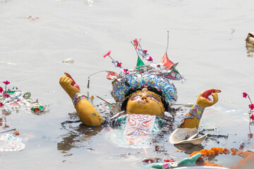Idol of Goddess Durga is being immersed at holy river Ganges, at the end of Durga Puja festival....