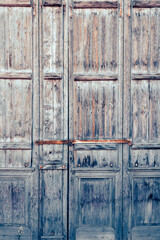 Locked old weathered obsolete wooden door