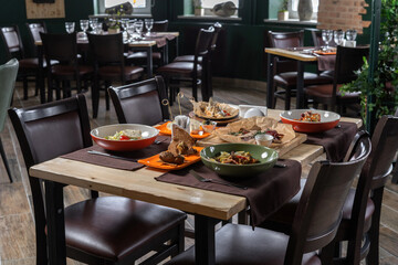 Fish grilled whole with tomatoes on a plate, in the background. You can see the interior of the restaurant.