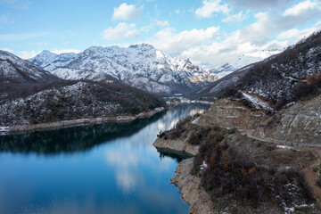 Mounains Lagoon Ancoa in the snow en region Maule, Chile. Aerial drone view.