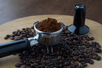 coffee beans and portafilter with fine coffee grind