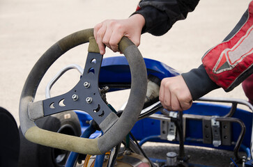 A child prepares a go-kart car for racing