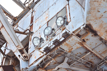 abandoned giant bucket wheel excavator stands in a field in winter