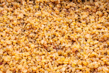 Dried grapes, raisins in market, texture background. Close-up.